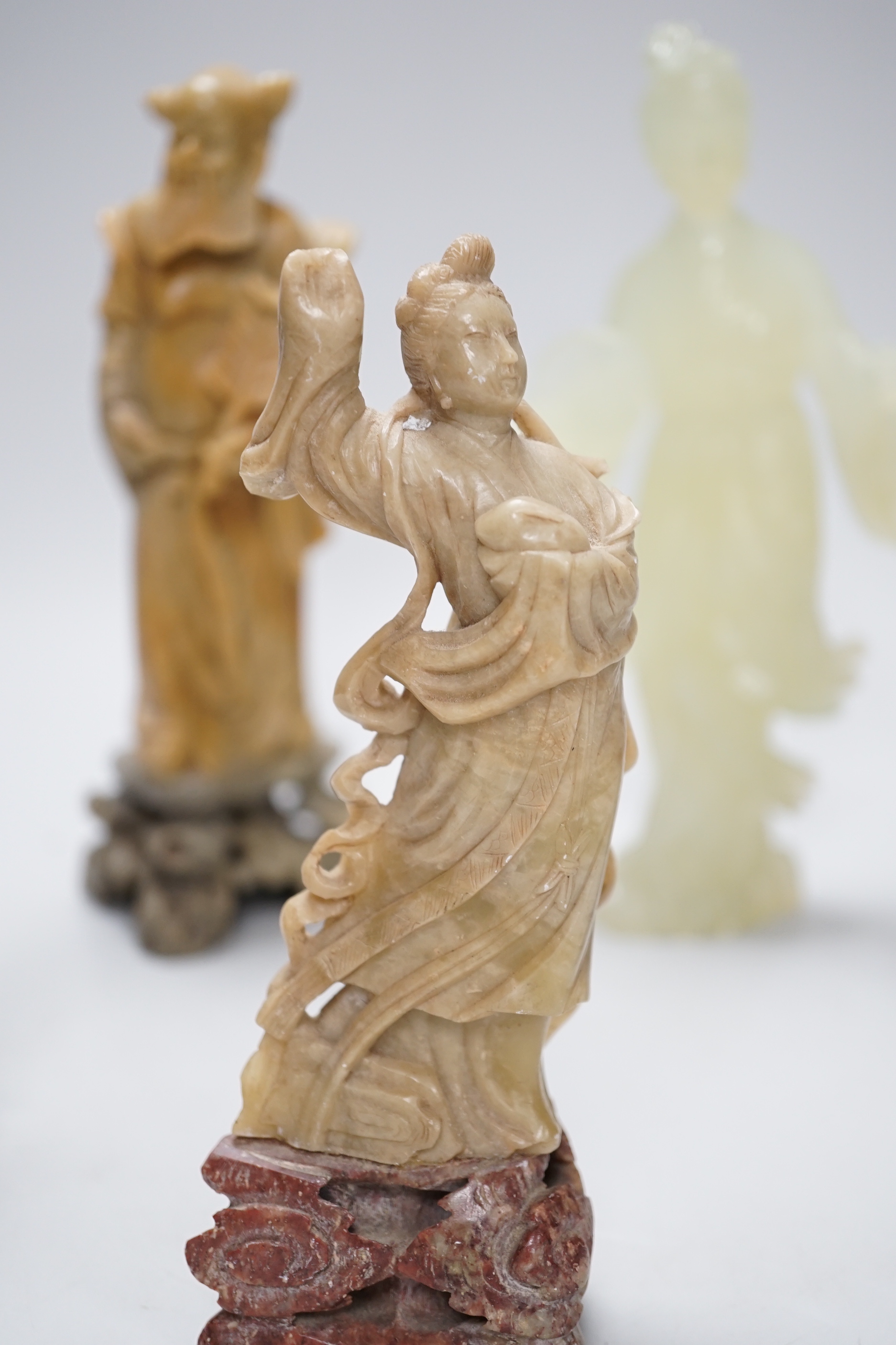 A Chinese bowenite figure and four Chinese carved soapstone figures, the largest 21cm high (5)